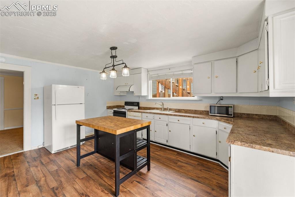Image 28 of 48: Updated kitchen with ample storage and prep space.