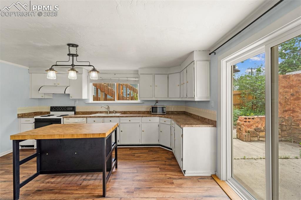 Image 29 of 48: Eat-in kitchen area with large window and natural light.
