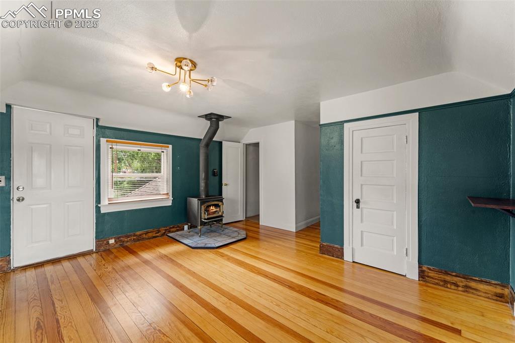 Image 34 of 48: Living area with hardwood floors and abundant light.