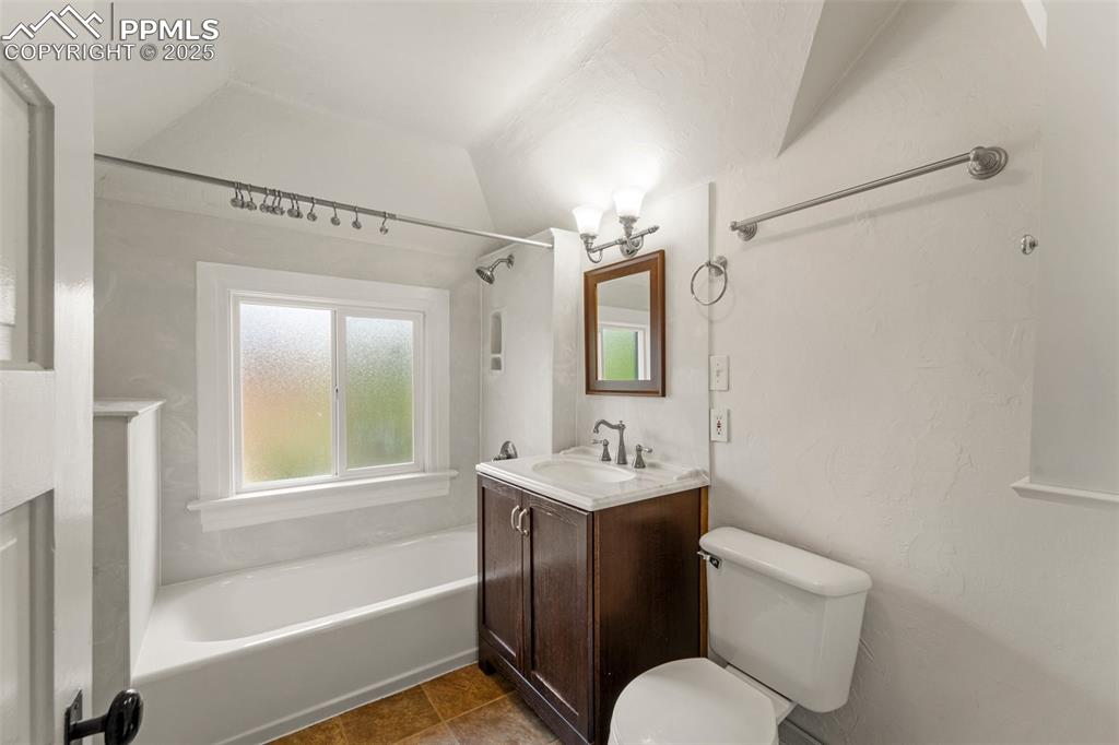 Image 38 of 48: Second bathroom with dual vanity and elegant design.