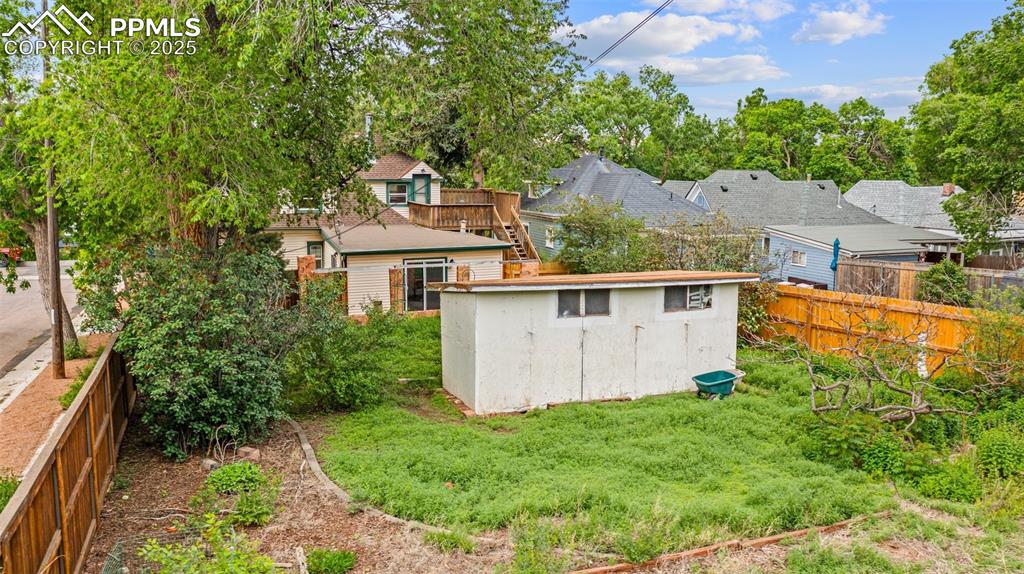 Image 7 of 48: Side yard with tree coverage for added privacy.