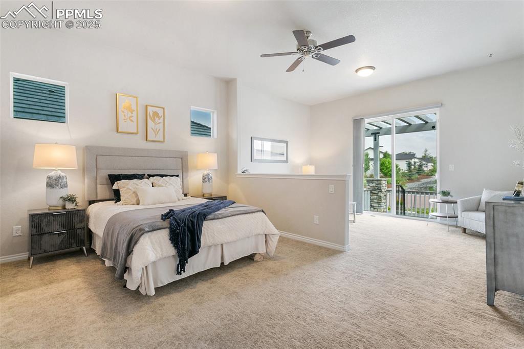 Image 19 of 41: Bedroom with access to exterior, carpet flooring, and ceiling fan