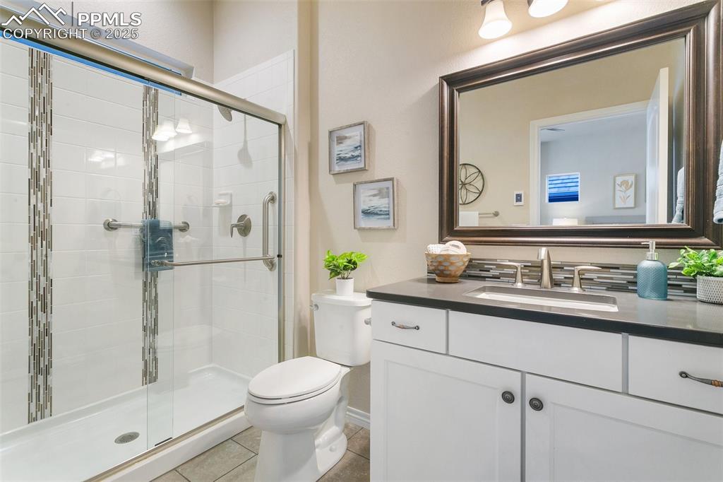 Image 20 of 41: Bathroom featuring vanity, a stall shower, and tile patterned floors