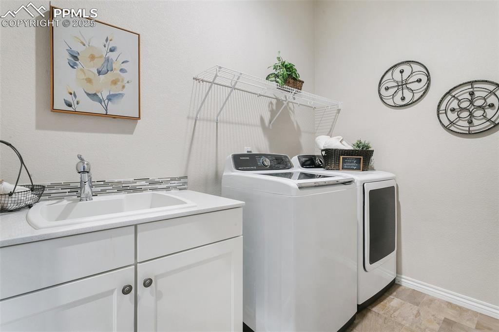 Image 21 of 41: Laundry room with washer and dryer and cabinet space