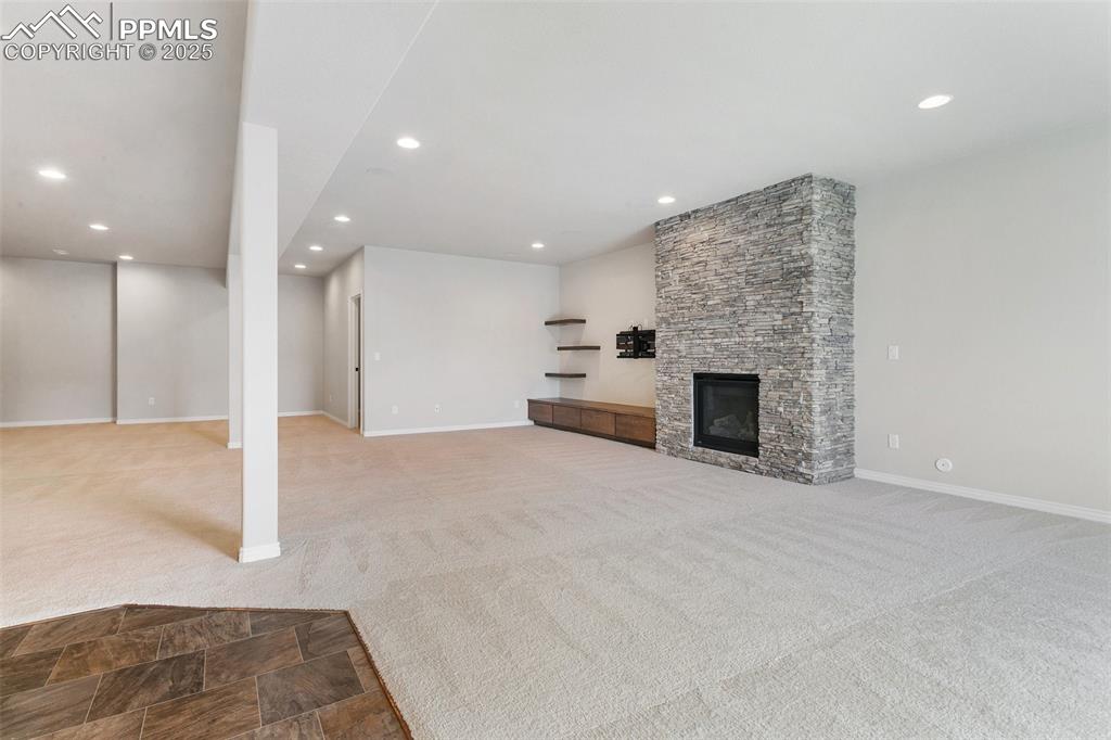 Image 23 of 41: Unfurnished living room featuring carpet floors, recessed lighting, and a f