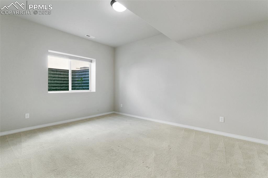 Image 26 of 41: Carpeted spare room with baseboards