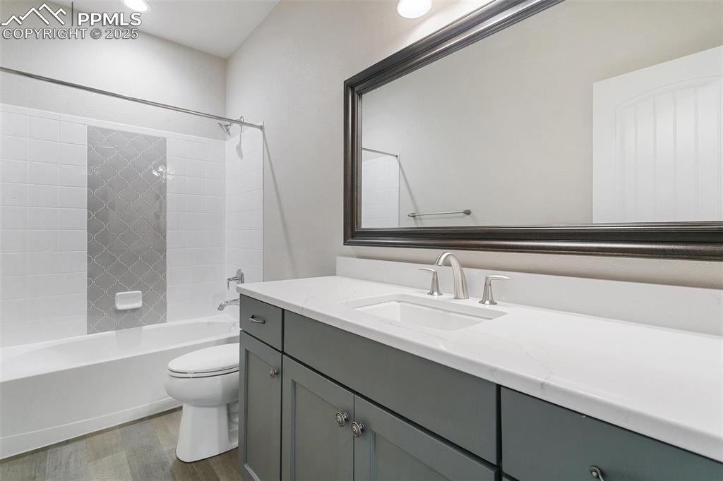 Image 30 of 41: Bathroom with wood finished floors, vanity, bathing tub / shower combinatio