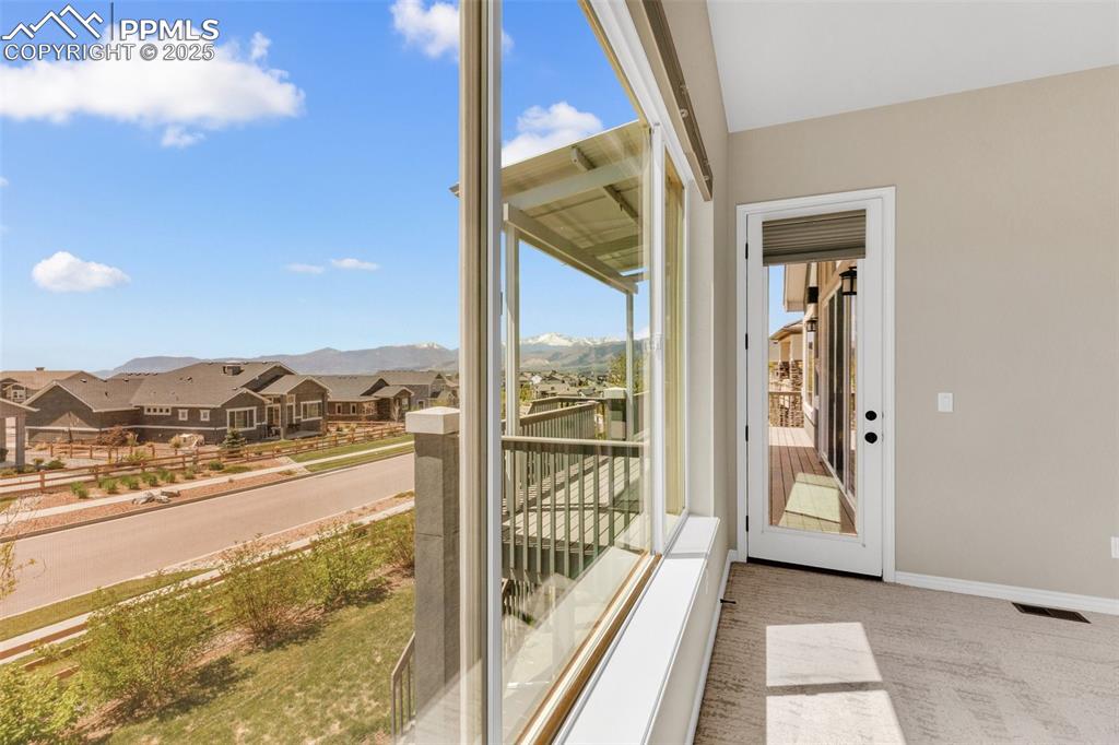 Image 34 of 41: Unfurnished sunroom featuring a residential view and a mountain view