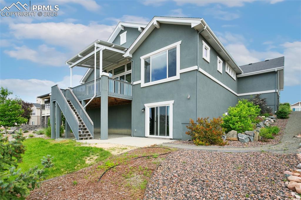 Image 36 of 41: Back of house with a patio, a deck, and stucco siding