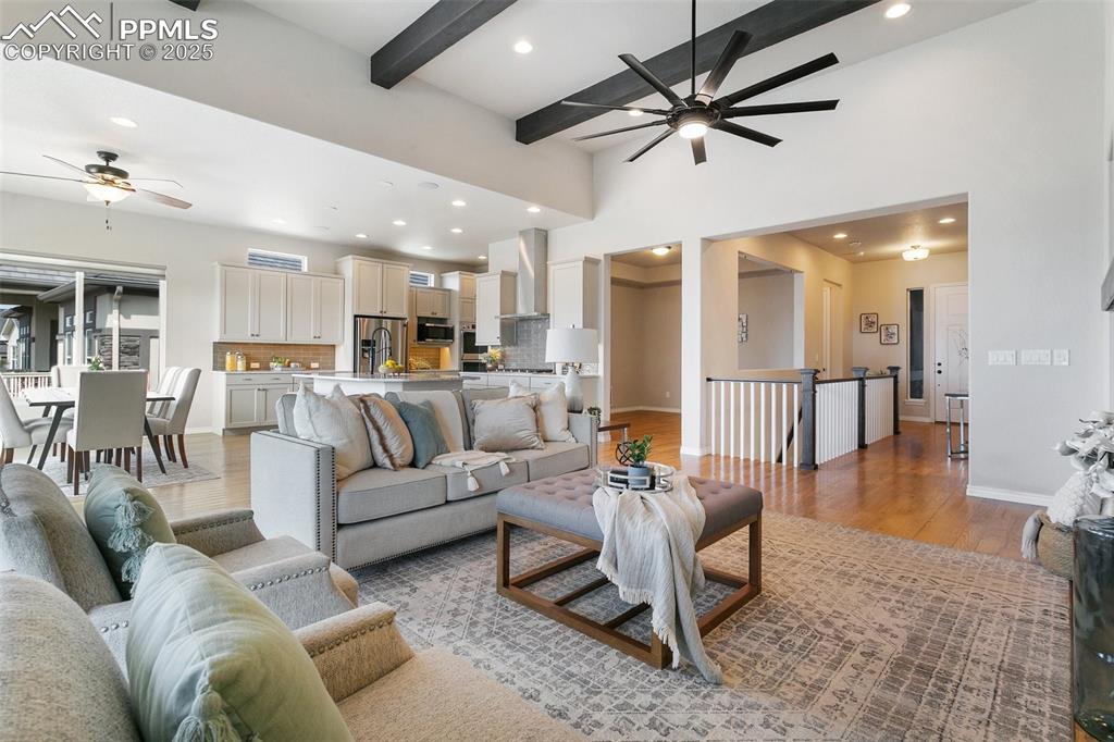 Image 8 of 41: Living room with a ceiling fan, recessed lighting, light wood-style floors,