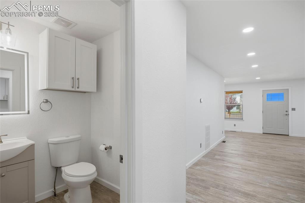 Image 13 of 37: 1/2 bath across from laundry room