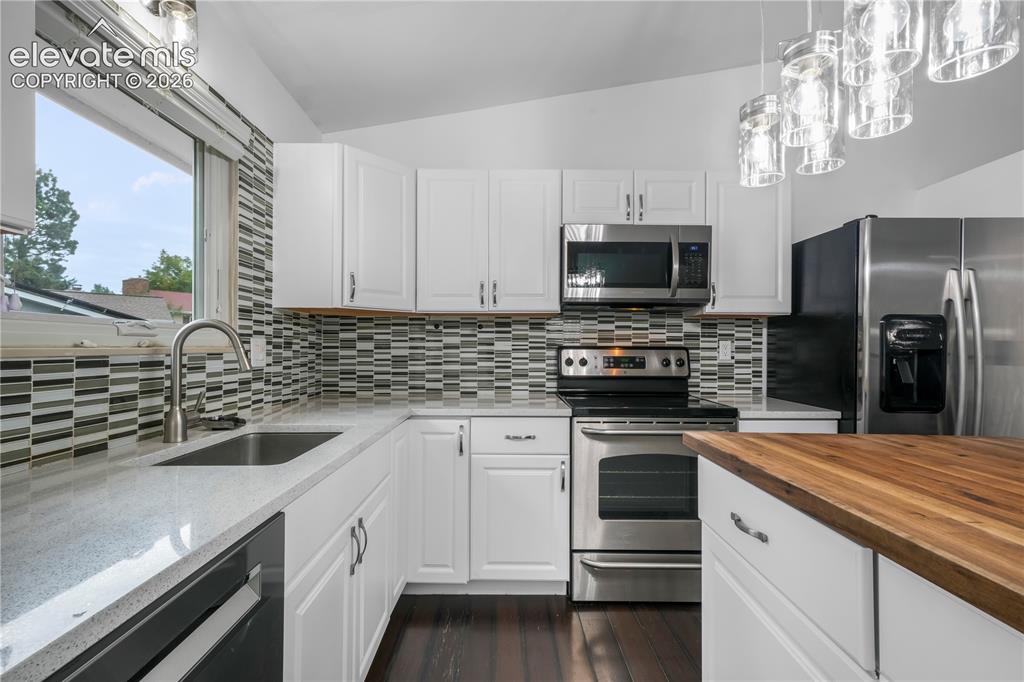 Image 11 of 50: Updated cabinets, granite counters, stainless steel appliances