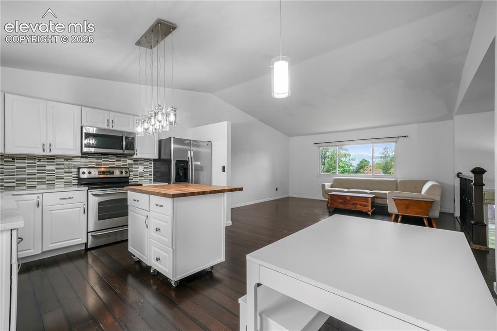 Image 12 of 50: Updated cabinets, granite counters, stainless steel appliances