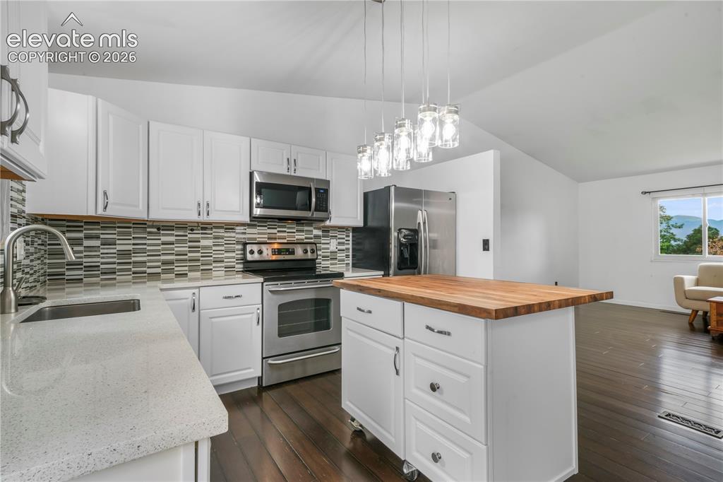 Image 13 of 50: Updated cabinets, granite counters, stainless steel appliances