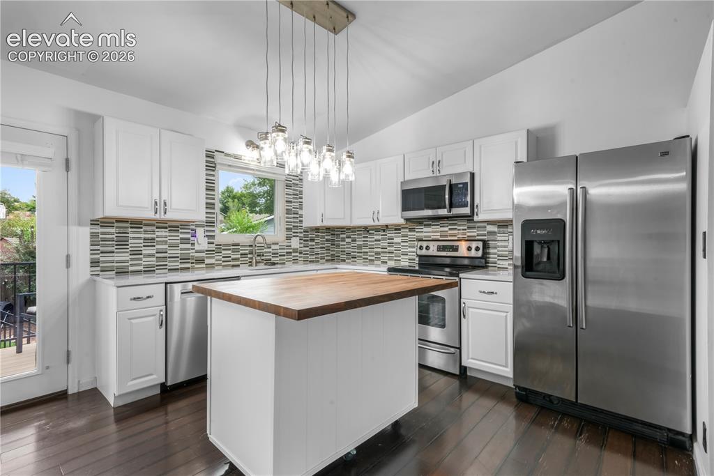 Image 14 of 50: Updated cabinets, granite counters, stainless steel appliances