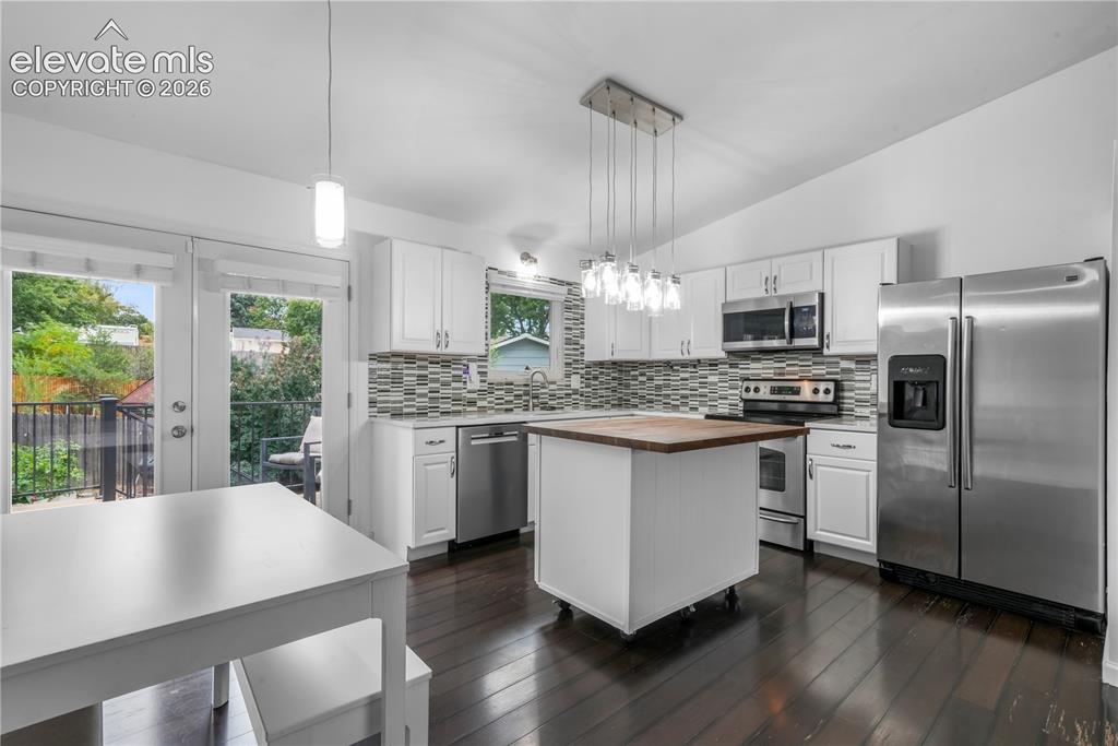 Image 15 of 50: Updated cabinets, granite counters, stainless steel appliances and views to