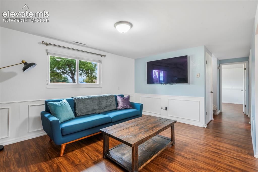 Image 23 of 50: Basement family room with fireplace, access to 2 more bedrooms, bathroom, l