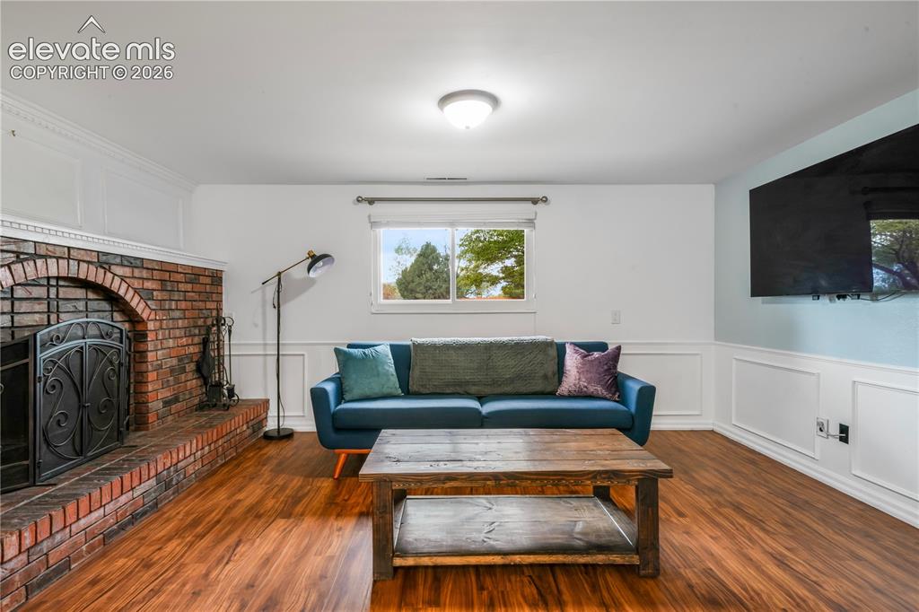 Image 24 of 50: Basement family room with fireplace, access to 2 more bedrooms, bathroom, l
