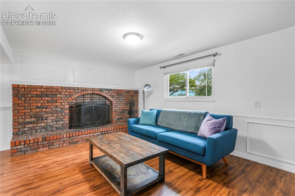 Image 25 of 50: Basement family room with fireplace, access to 2 more bedrooms, bathroom, l
