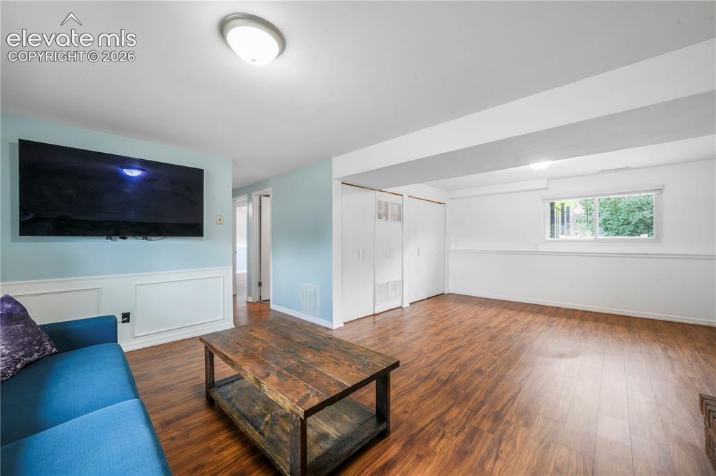 Image 26 of 50: Basement family room with fireplace, access to 2 more bedrooms, bathroom, l