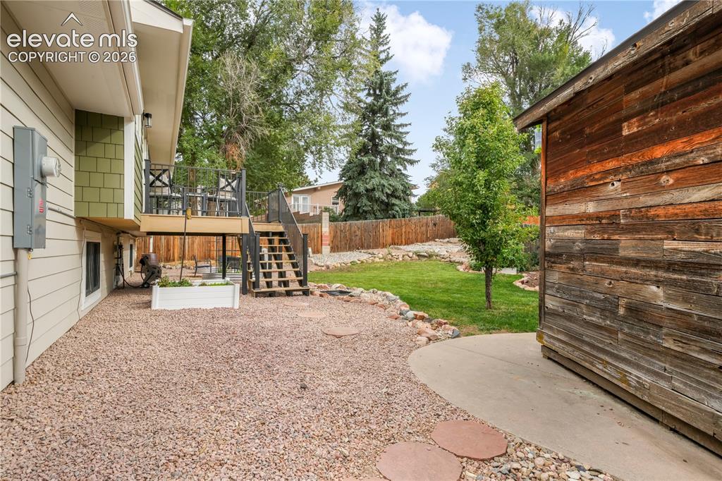 Image 43 of 50: Back yard with entertaining areas, shed, landscaped, garden areas and priva