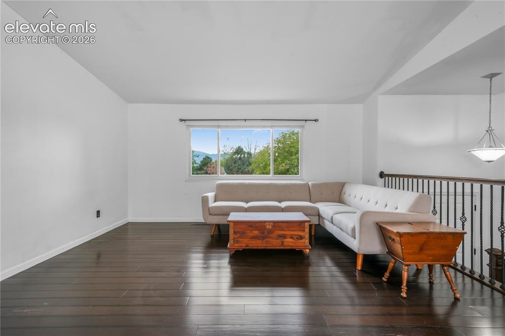 Image 6 of 50: Views of front door entrance and upper living room with vaulted ceilings an
