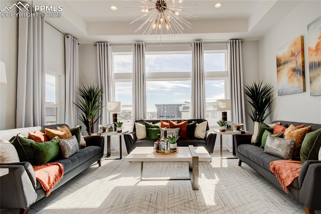Image 10 of 30: Living area featuring a chandelier, recessed lighting, and a tray ceiling