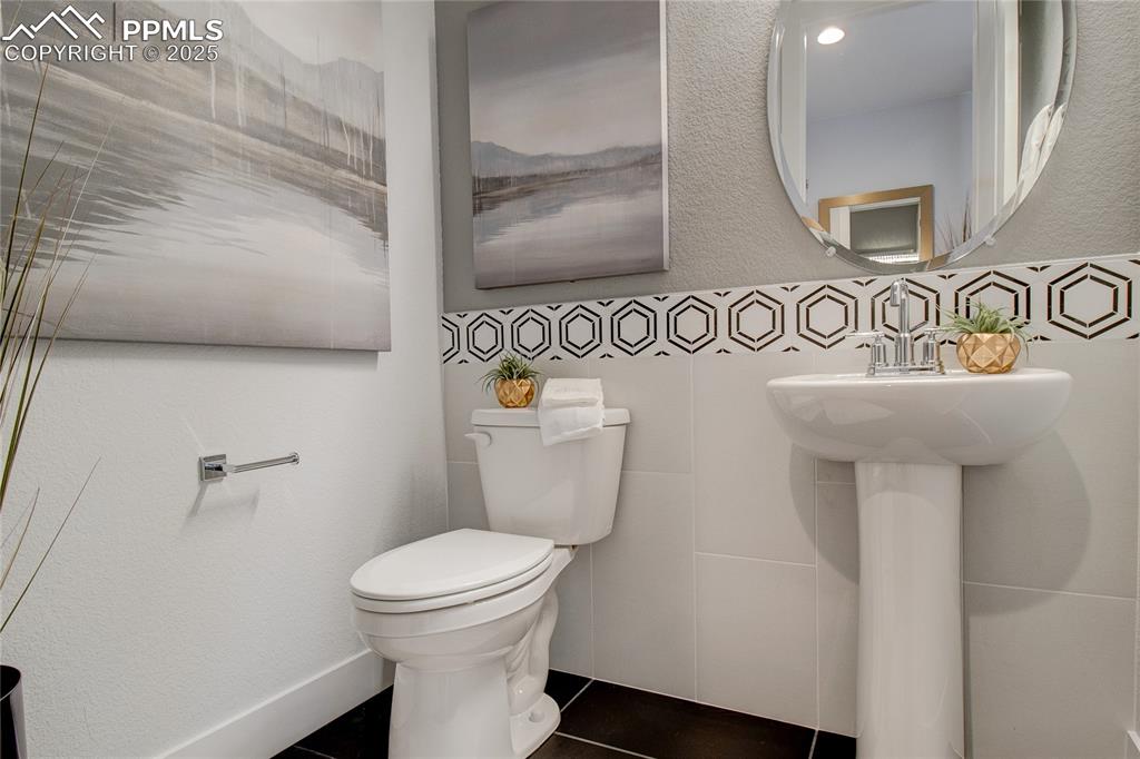 Image 19 of 30: Bathroom with tile patterned flooring, toilet, and a sink