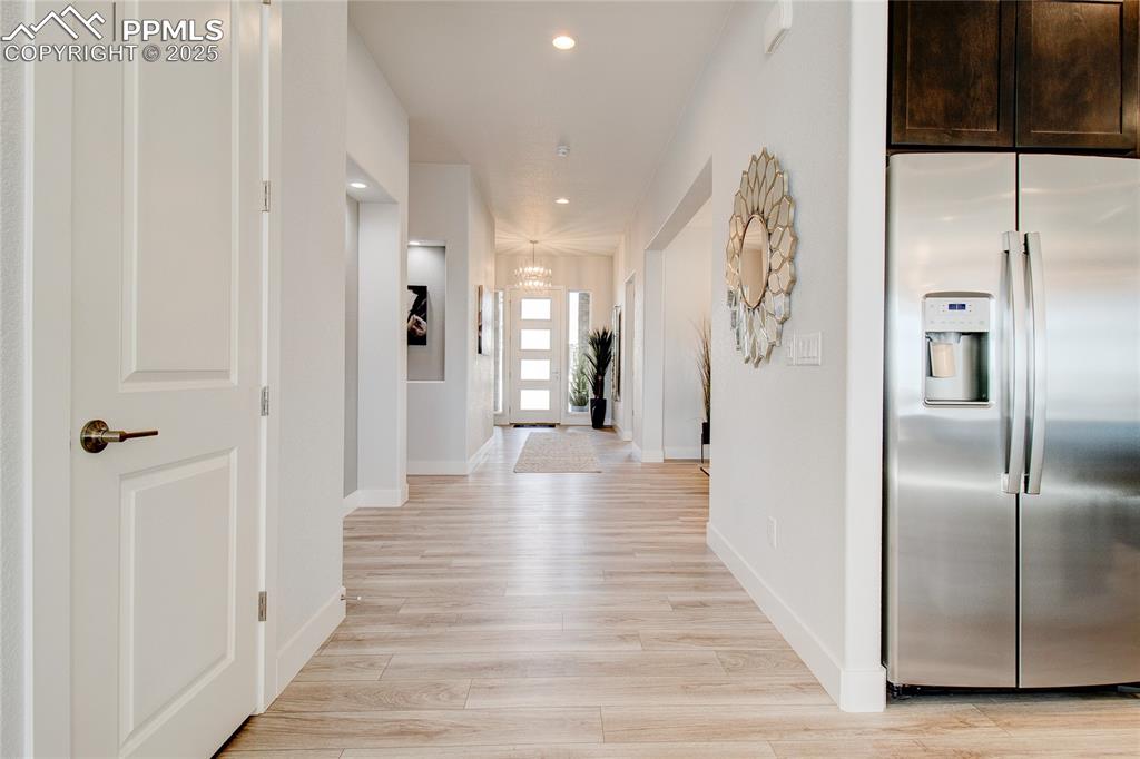 Image 20 of 30: Hallway featuring light wood-type flooring, baseboards, recessed lighting, 