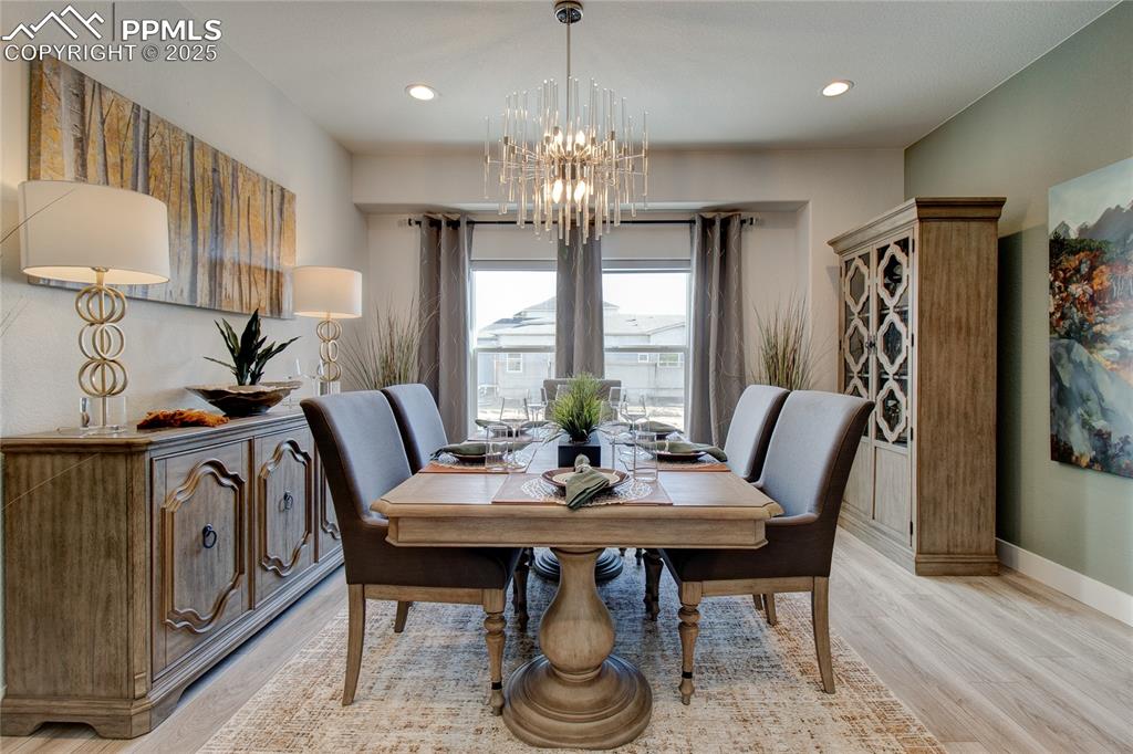 Image 3 of 30: Dining room with a chandelier, light wood-style floors, baseboards, and rec