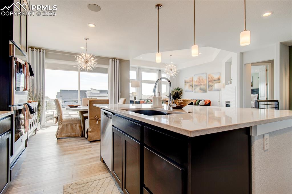 Image 7 of 30: Kitchen featuring a sink, open floor plan, light wood-type flooring, light 