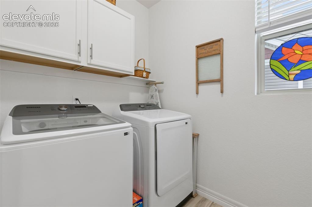 Image 12 of 34: Laundry with additional cabinets