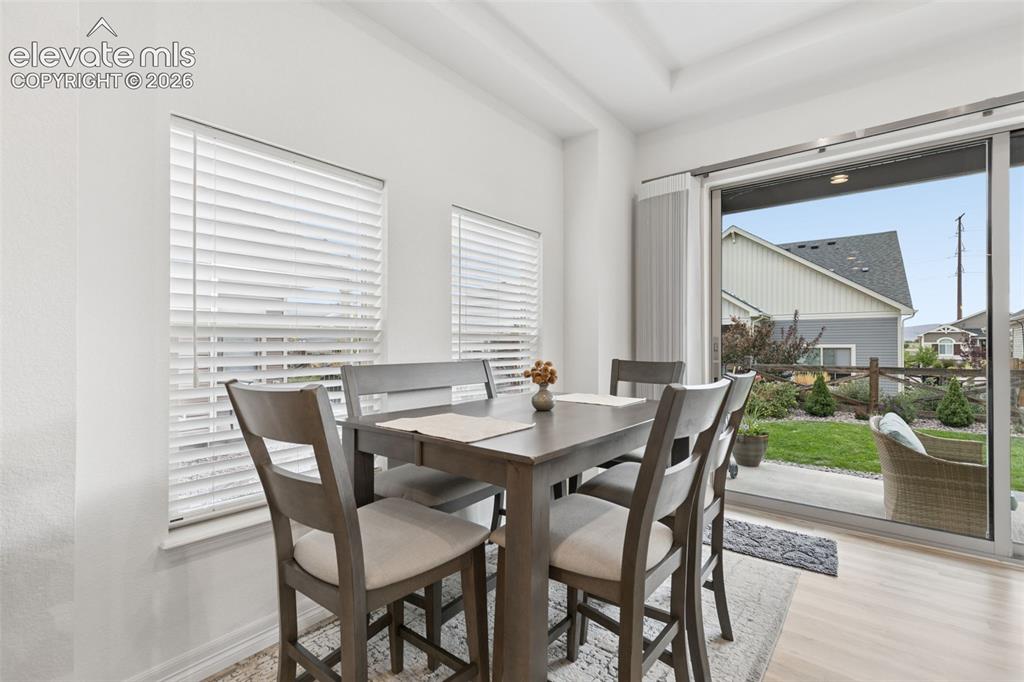 Image 19 of 34: Dining area overlooking patio through Colroado Doors
