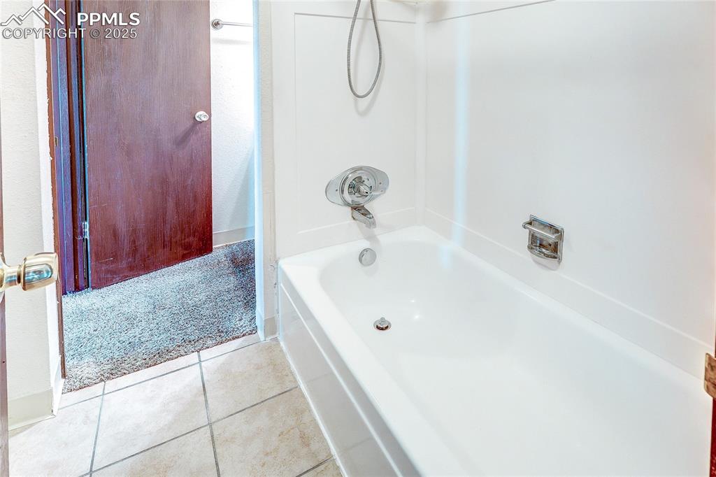 Image 13 of 20: Bathroom featuring tile flooring and tub / shower combination