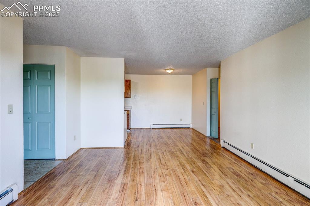 Image 19 of 20: Living and dining room with wood laminate flooring.