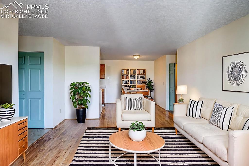 Image 2 of 20: Large living/dining area with updated wood laminate flooring. Virtually Sta