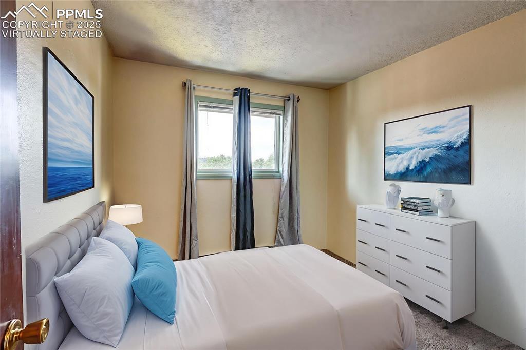 Image 9 of 20: 2nd Bedroom with mountain view.  Virtually Staged.