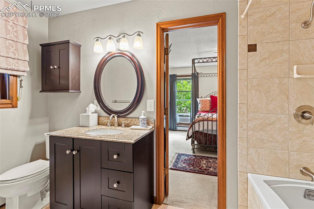 Image 22 of 49: Main level jack and Jill bath