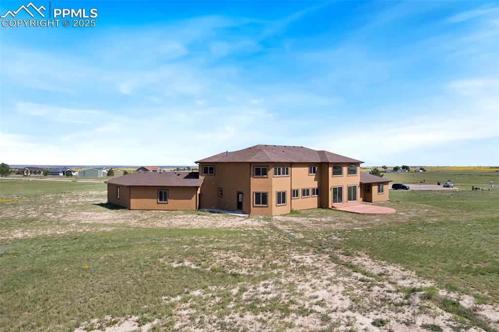 Image 45 of 45: Rear view of property with stucco siding, a yard, and a patio area