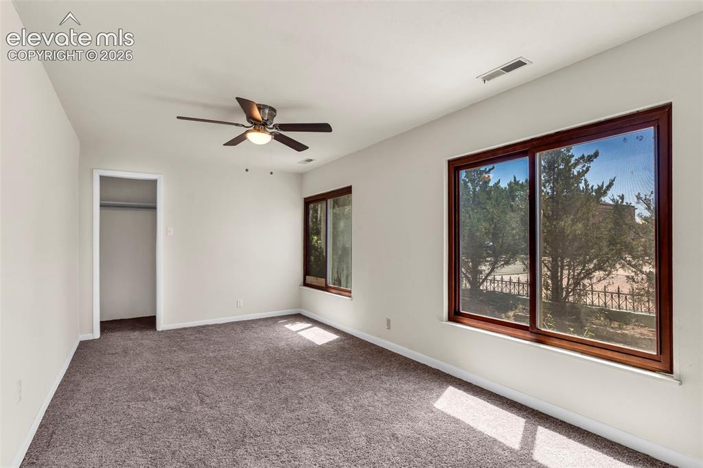 Image 11 of 29: Spacious room featuring neutral carpeting, light-toned walls, and a ceiling