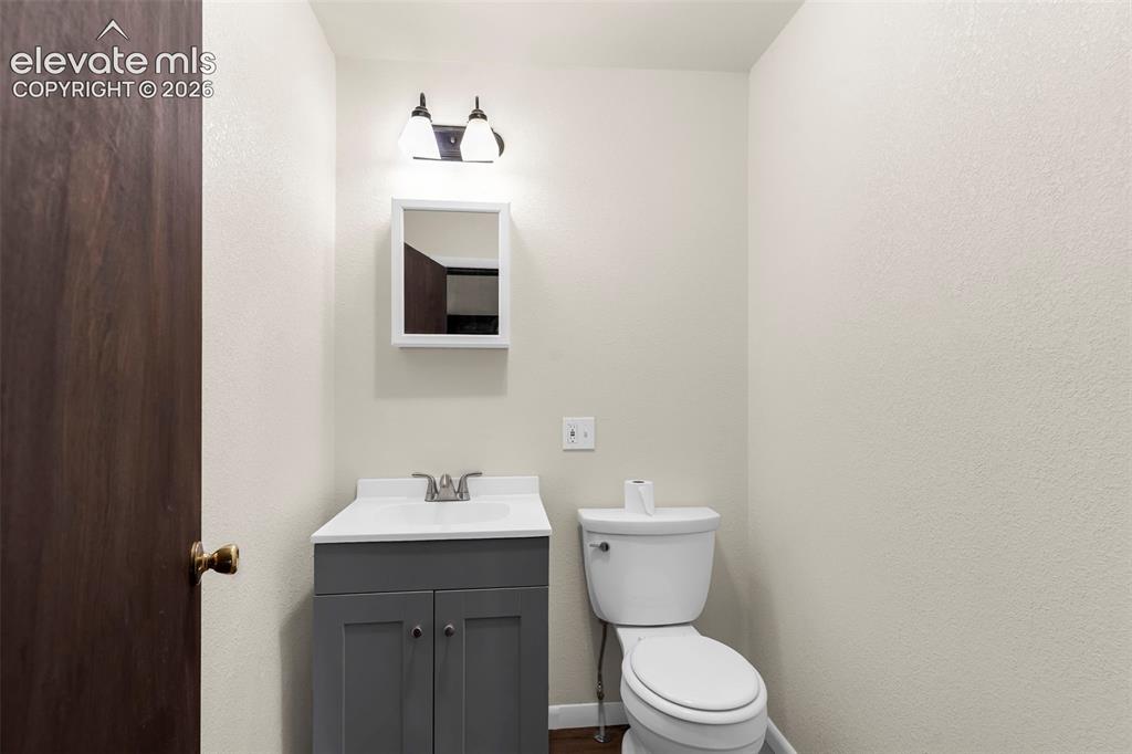Image 13 of 29: Bathroom featuring a gray vanity with an integrated white sink, a white fra