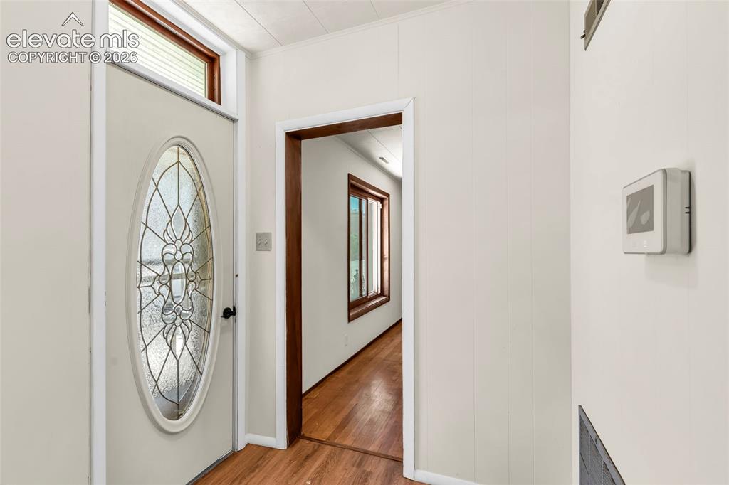 Image 5 of 29: Entryway featuring a decorative oval glass insert door with a transom windo