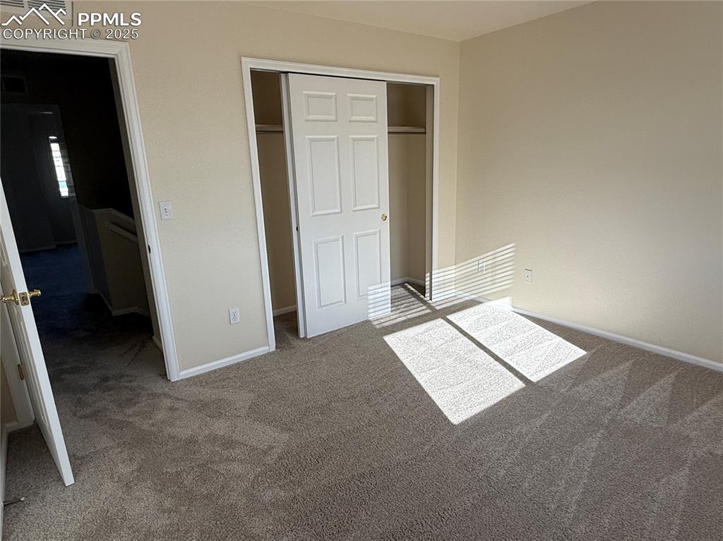 Image 21 of 32: Unfurnished bedroom featuring carpet and a closet