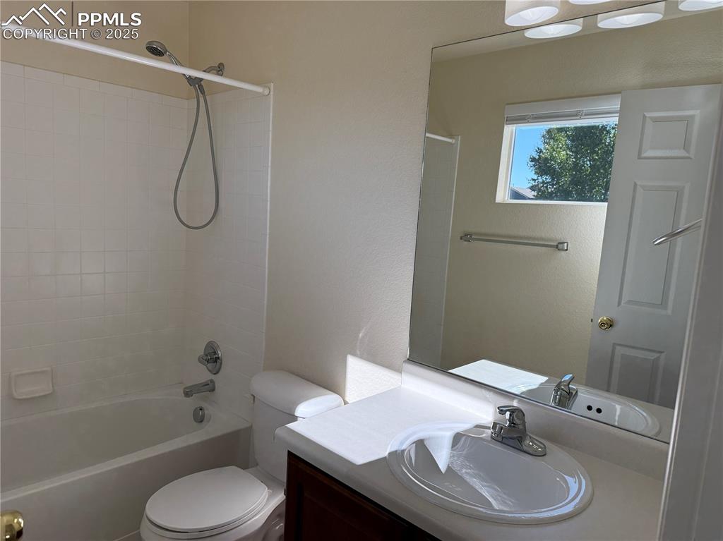 Image 23 of 32: Full bath with bathtub / shower combination, vanity, and a textured wall