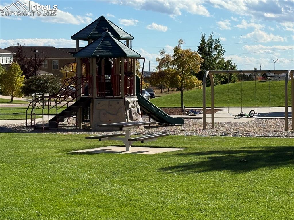 Image 30 of 32: Communal playground with a lawn