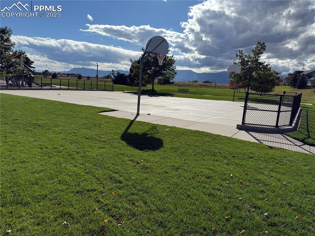 Image 32 of 32: View of sport court with a mountain view and community basketball court