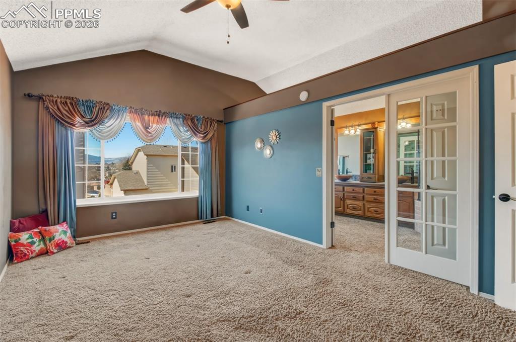 Image 11 of 35: French doors to the 5-piece master bathroom. 