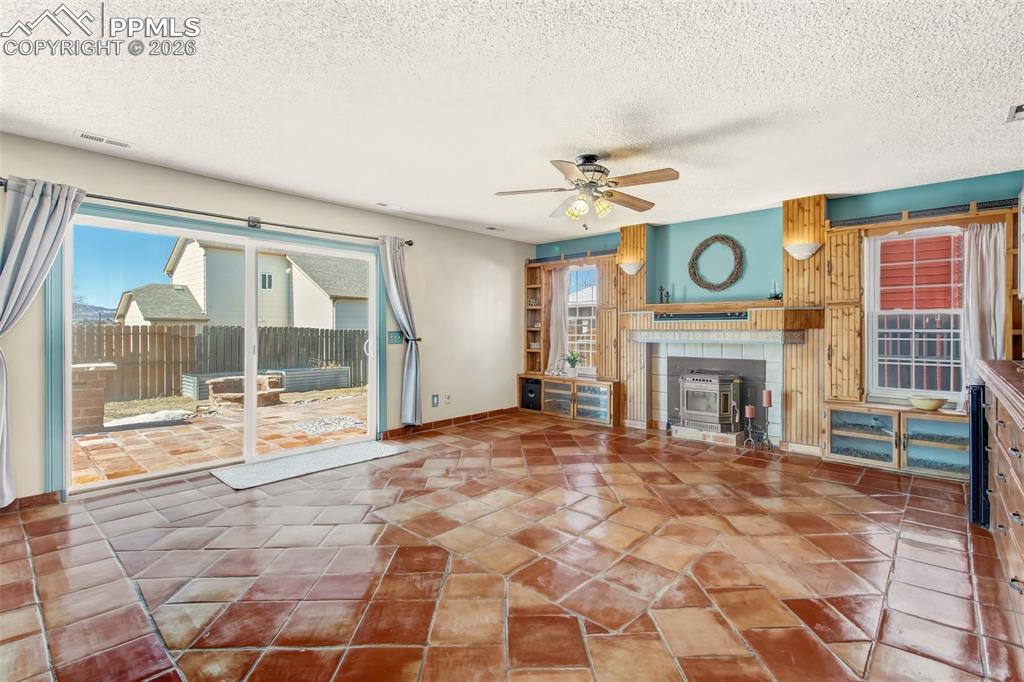 Image 21 of 35: Wall to wall tile floors, Whitfield pellet stove and beautiful built-ins. 