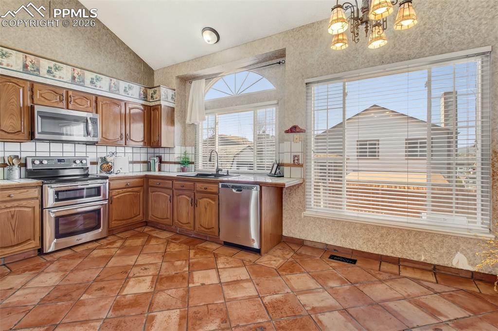Image 6 of 35: Large window over the kitchen sink allows plenty of natural light. 