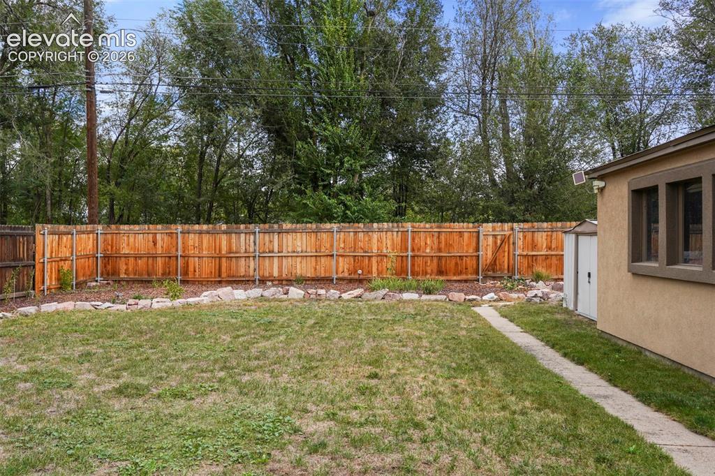 Image 13 of 23: Back yard with newer rear fence